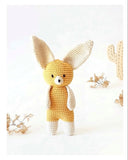 Crocheted fox toy with text on a white background