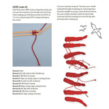 A printed instruction page showing how to make a knitted crab, with labeled parts, measurements, and step-by-step assembly instructions alongside diagrams.