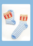 A two-page printed booklet or magazine spread showing a pair of blue and white striped socks with red knit patterns on the left, and product photos plus a long text paragraph on the right under the heading 'Lobster Socks.'.