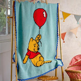 A crocheted 'Winnie the Pooh Baby Blanket' by Melissa Rose-Gary, showing a finished blue blanket with a red balloon and Winnie the Pooh design.