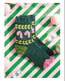 Knitted sock with holly design on a striped background, accompanied by knitting instructions.