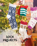 Colorful knitted Christmas stockings hanging on a line with a festive background.