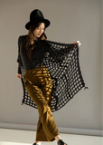 Person wearing a black lace shawl.