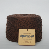 Brown yarn ball with a 'spin up' label on a light gray background