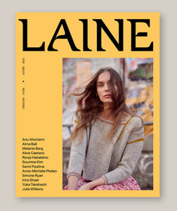 Magazine cover with 'Laine' branding and a person wearing a knitted sweater.