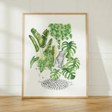 Framed artwork of green plants and a cat on a white background