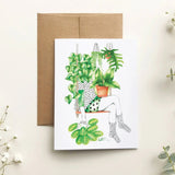 Greeting card with a plant-themed design on a light background with decorative plants.